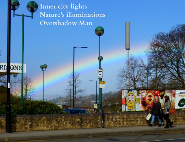 rainbow over the city streetlights